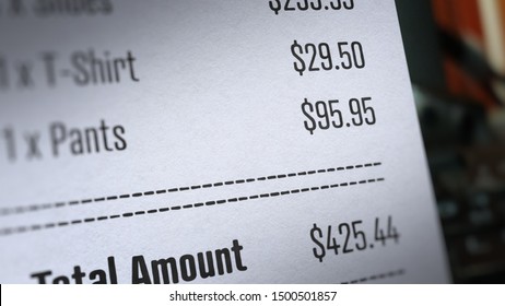 Receipt Paper With Total Amount With Selective Focus And Blurry Image
