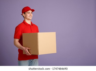 Received Parcel From Shopping Store. Smiling Courier In Uniform Holding Big Box Isolated On Gray Background