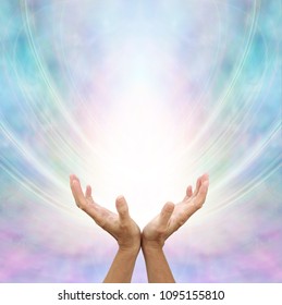 Receiving Divine Source Of Healing - Hands Cupped And Facing Up Towards White Light And Blue Pink Energy Formation Background With Copy Space                        