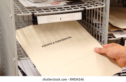 Receiving A Private And Confidential Envelope In The Office Mailroom.