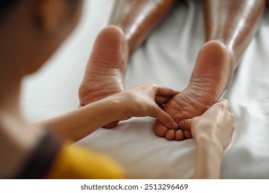 Receiving Professional Foot Massage Therapy Session - Powered by Shutterstock