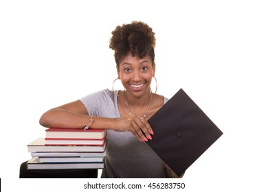 Recent College Graduate Next To A Stack Of Books