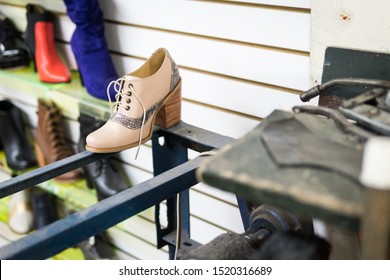 Recently made shoe / heels (lita) in a shoes factory / workshop. It is pink and it is next to the manufacturing machines. There are boots at the back. Taken in Restrepo, Bogota, Colombia. - Powered by Shutterstock