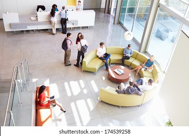 Reception Area Of Modern Office Building With People