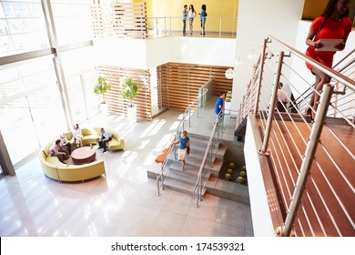 Reception Area Of Modern Office Building With People