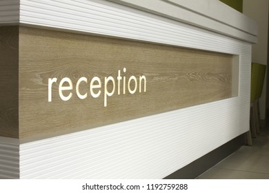 Reception Desk Sign On Front Of Counter