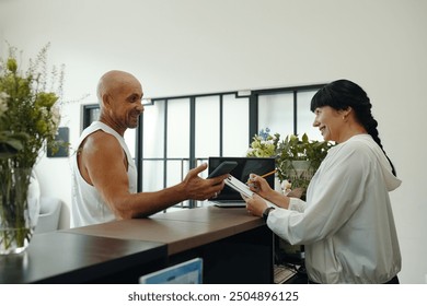 Receptionist Discussing Timetable With Client - Powered by Shutterstock