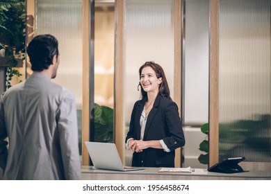 Receptionist  at hotel front desk  welcoming at Counter 