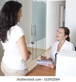 Receptionist Making An Appointment In A Clinic