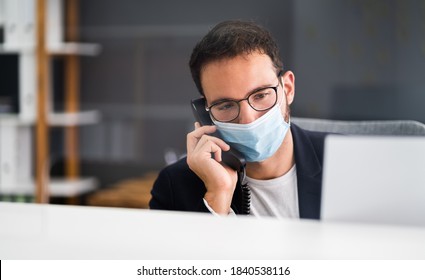 Receptionist Man At Office Reception Wearing Face Mask