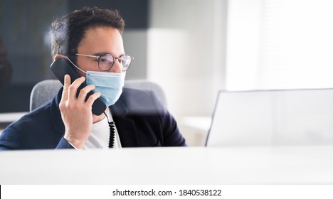 Receptionist Man At Office Reception Wearing Face Mask