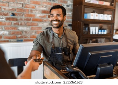 Receptionist taking payment for the customers. African American barber, black small business owner, African American business. Barbershop and happy barber. - Powered by Shutterstock