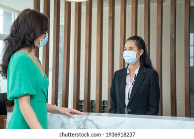 Receptionist Wearing Mask To Protect From Coronavirus Covid 19 Are Talking Customers Who Come To Stay At The Hotel.