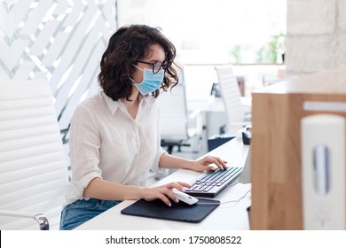 Receptionist Wearing Medical Mask In Office. Protection Employees On Workplace. Young Woman Working At Reception In Hotel. Social Distancing During Quarantine, Staff Safety.