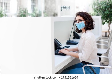 Receptionist Wearing Protective Mask At Reception In Hotel. Protection Employees On Workplace. Young Woman Working In Office. Social Distancing During Quarantine, Staff Safety.