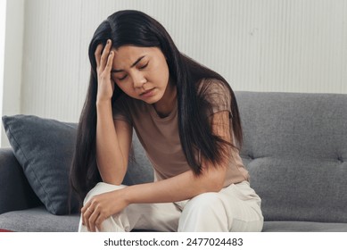 Recession Stress Woman work hard at home office headache depressed failure business burnout sitting on sofa. Tired Asian woman despair stress overworked frustration pain panic depression life crisis