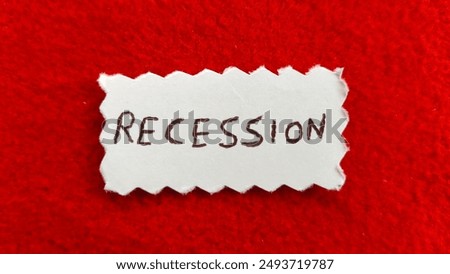 Recession word letters text handwritten calligraphy design on white paper label note isolated on a red background surface with copy space. Closeup macro top view. Recession creative concept.