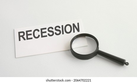 recession word on white paper card and magnifying lens - Shutterstock ID 2064702221