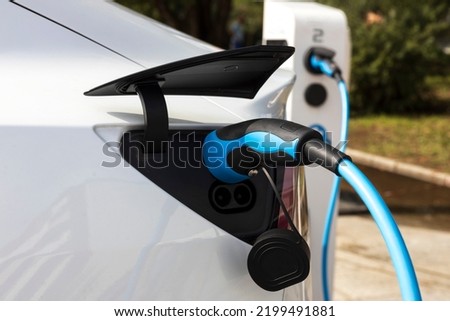 Recharging of a Modern Electric Car on a Town Free Electric Car Charging Space