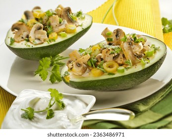 A recipe of avocado stuffed with a mix of slices of mushrooms,fresh onions,coliander and other aromatic herbs.