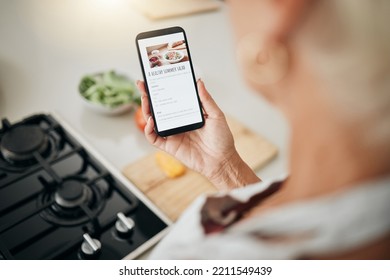Recipe, cooking and healthy food list on a phone screen with a woman to cook in a kitchen home. Nutritionist person ready to start health, nutrition and vegetables for a meal using mobile technology