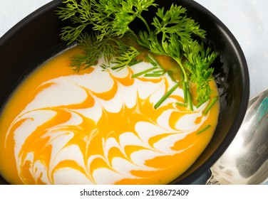 Recipe Of Healthy Pumpkin Cream Soup With Ginger: Roast Pumpkin In Olive Oil, Beat In Blender With Vegetable Broth. Add Whisked Cream With Garlic And Ginger. Serve With Greens..