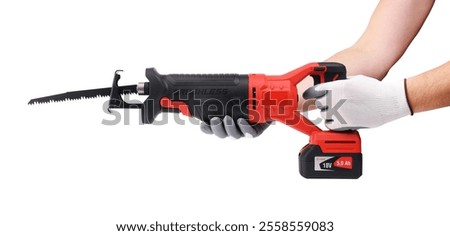 A reciprocating saw in the hands of a worker.