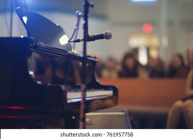 Recital Music Performance Large Venue With Grand Piano And Microphone. Shot From Back Of Stage. 