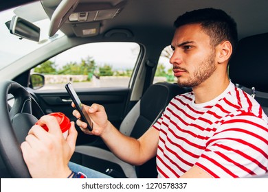 A Reckless Young Man Is Driving His Car While Is Having Coffee And Phone In His Hands, Potential Danger, Near Miss