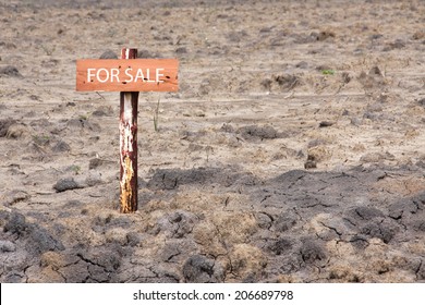 reclamation land area with wooden sign pole for sale