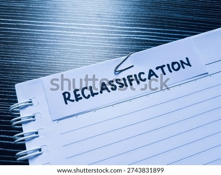 Reclassification writting on table background. 