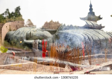 Reclining Buddha Close Up And Incense Stick Multiple Exposure In Dafo District, Foshan Sanshui Forest Park, Guangdong