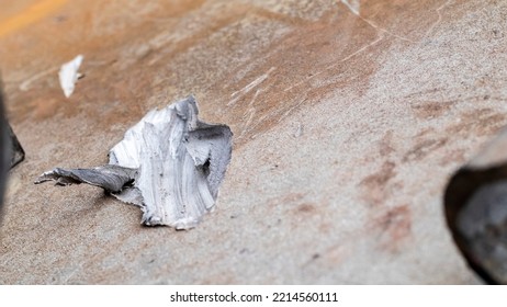 Recochet From A Bullet Or Shell Fragment On Military Armored Vehicles. Texture Of Camouflage Armored Metal With Damage Close-up. Armor Metal Background. Armor Deformation From A Shell Close-up