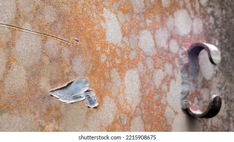 Recochet From A Bullet Or Shell Fragment On Military Armored Vehicles. Texture Of Camouflage Armored Metal With Damage Close-up. Armor Metal Background. Armor Deformation From A Shell Close-up