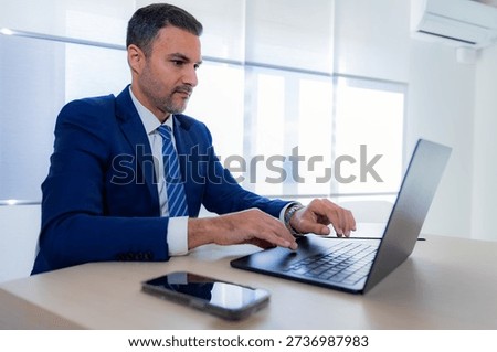 recognizable man typing on his laptop