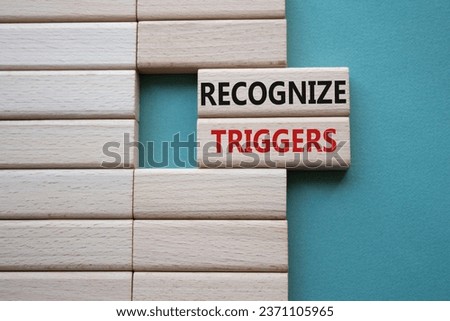 Recognize triggers symbol. Concept words Recognize triggers on wooden blocks. Beautiful grey green background. Business and Recognize triggers concept. Copy space.