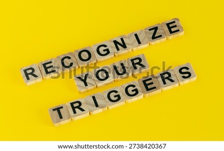 Recognize your triggers message on a yellow background - concept of mental triggering and self-awareness.