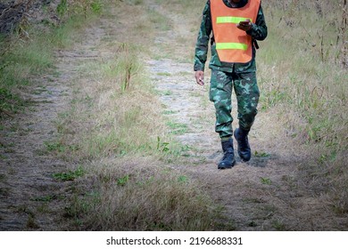 Reconnaissance infantry using cell phones in fields to send news to Combat Headquarters. Army soldier in uniform using mobile phones to inspect surrounding terrain. Military communication technology. - Shutterstock ID 2196688331