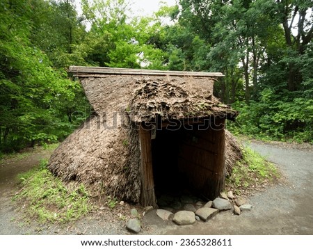 Reconstructed pit dwelling in the Jomon Village ruins garden in Tokyo