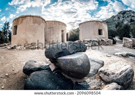 Reconstructed round houses of Neolithic era and stone tools at the archaeological site of Choirokitia settlement, Cyprus