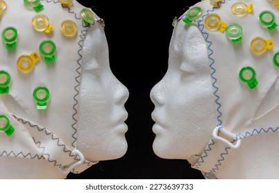 Reconstruction of the Famous fase-vase illusion, using two dummy heads and an EEG electrode cap. - Powered by Shutterstock