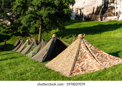 Reconstruction of a World War II military camp during a reenactment event. German military tents from World War II.