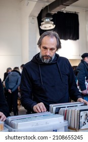 Record Collector Browsing Through Music LP Vinyl Albums On The Flea Market Of Old Gramophone Records. Vintage Sound Fans. Vertical Orientation. Selective Focus.