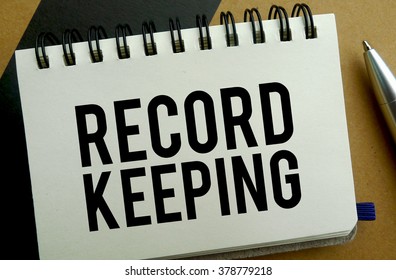 Record Keeping Memo Written On A Notebook With Pen