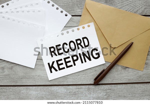 Record keeping text on a white sheet of paper\
near the envelope