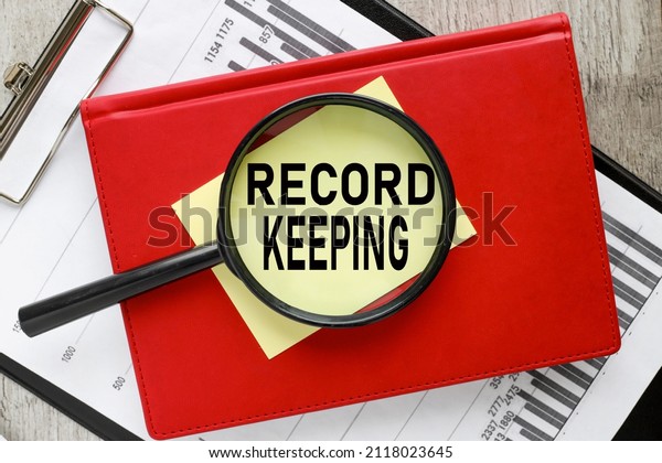 RECORD KEEPING yellow sticky sticker under a\
magnifying glass. text on\
glass