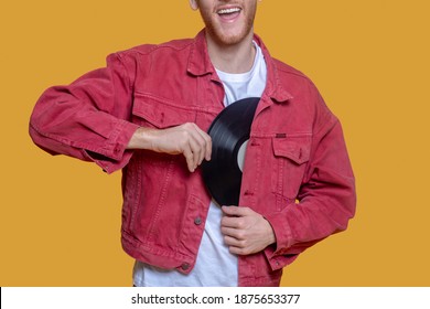 With record. Man in red jacket with a record