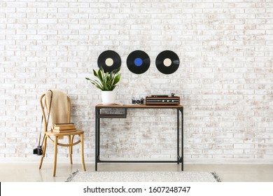 Record Player With Vinyl Disc On Table In Interior Of Room