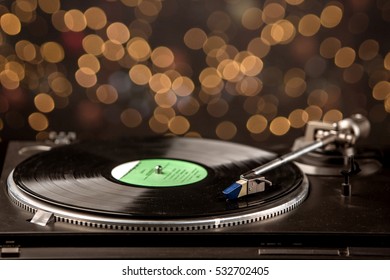 Record Player With Vinyl Record And Holiday Bokeh On Background