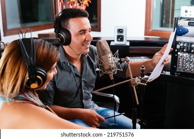 Record producer showing young singer the right way to perform the song - Powered by Shutterstock